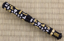 Load image into Gallery viewer, The Fountain Pen with the cap on. It is made of black lacquer with encrusted pieces of silver and gold vermeil . The silver pieces have a small pave of diamonds within them.