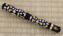 Load image into Gallery viewer, The Fountain Pen with the cap on. It is made of black lacquer with encrusted pieces of silver and gold vermeil . The silver pieces have a small pave of diamonds within them.