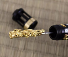 Load image into Gallery viewer, Angled close up to the gold vermeil dragon which functions as the piston.