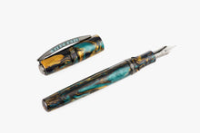 Load image into Gallery viewer, Angled view of the Visconti Earth Origins Fountain Pen on a white background. The pen and cap are made of blue, yellow and dark brown swirls of lacquer, and feature metal trims.