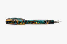 Load image into Gallery viewer, Horizontal view of the Visconti Homo Sapiens Earth Origins Fountain Pen with the cap posted. The pen and cap are made of blue, yellow and dark brown swirls of lacquer, and feature metal trims.
