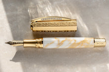 Load image into Gallery viewer, Horizontal view of the Visconti Il Magnifico Calcatta Gold Fountain Pen. The barrel is made of white and yellow resin. The Cap, and bottom of the pen have matching accents and decorations.