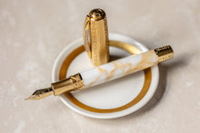 Load image into Gallery viewer, Visconti Il Magnifico Calcatta Fountain Pen laid with the cap behind it on a small white plate.