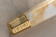 Load image into Gallery viewer, Close up to the bottom part of the Visconti Il Magnifico Calcata Pen. it has engraved designs of a fleur de lis and other marks.