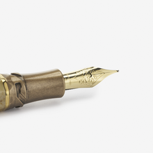 Load image into Gallery viewer, Close up to the Visconti Il Magnifico Egyptian Marble Fountain Pen nib. It has a series of engraved decorations with the word VISCONTI, 18KT 750, and the letter F.