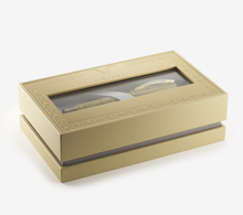 Load image into Gallery viewer, Angled view of the presentation box for the Visconti Il Magnifico Egyptian Marble Fountain Pen. It is a golden bronze color and the top has a thin frame of embossed decorations.
