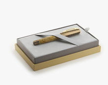 Load image into Gallery viewer, The Visconti Il Magnifico Egyptian Marble Fountain Pen set on the presentation box under the strap.