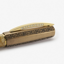 Load image into Gallery viewer, Close up to the Visconti Il Magnifico Egyptian Marble Fountain Pen cap. The clip has an engraving of the word VISCONTI on the sides. The cap has a series of engravings with fleur de lis and other decorations on the sides.
