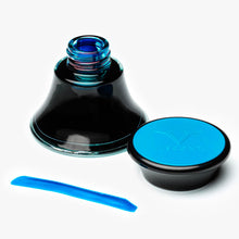 Load image into Gallery viewer, The turquoise ink bottle with the cap set to the side. An ink stripe is shown in front.