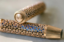 Load image into Gallery viewer, Close up to the cap top of the Visconti Looking East Fountain Pen. it has an engraved Visconti logo V.