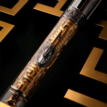 Load image into Gallery viewer, Pen with intricate maze design on a black and gold background.