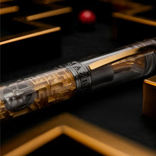 Load image into Gallery viewer, Luxury pen with intricate maze design and gold accents on a dark background.