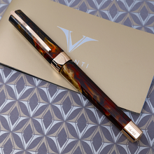 Load image into Gallery viewer, Front view of the Fountain Pen a top the presentation box and booklet.