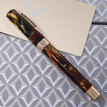 Load image into Gallery viewer, Side view of the fountain pen. The side of the cap clip has the word VISCONTI engraved.