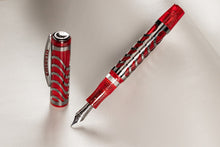 Load image into Gallery viewer, The Visconti Skeleton Ruby Red fountain pen on a light gray background. The cap is standing next to the angled pen.