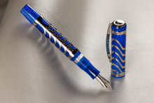 Load image into Gallery viewer, Visconti Skeleton Sapphire Blue Fountain Pen with the cap set to the side on a light gray textured background.