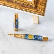 Load image into Gallery viewer, The Fountain Pen laid on white marble with the cap set behind it.