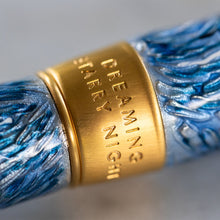 Load image into Gallery viewer, Close up to the engraving of the back of the cap ring. It reads: DREAMING STARRY NIGHT