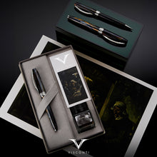 Load image into Gallery viewer, The Fountain, rollerball, and ballpoint pen versions arranged with the presentation box, ink and a gray and black gradient.