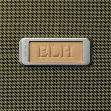 Load image into Gallery viewer, Briggs & Riley Baseline Expandable Essentials Kit - Olive
Image of Leather Name Patch, allowing for embossing up to 3 block style initials.
Height	Width	Depth	Weight
US	6 in.	11 in.	4.5 in.	.8 lbs.
EU	15.2 cm	27.9 cm	11.4 cm	0.4 kg