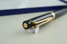Load image into Gallery viewer, Top view of mechanical pencil. It has a hexagonal medal with a W inside.