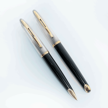 Load image into Gallery viewer, Front view of the ballpoint pen and mechanical pencil on a white background. The top halves are silver with golden trims. The bottom halves are made of black lacquer with golden trims.