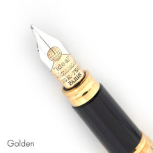 Load image into Gallery viewer, Close up to the nib of the golden fountain pen. It is bi-colored, and has an engraving of the globe icon, the word Ideal, the Waterman logo, 18K-750, and the word PARIS.