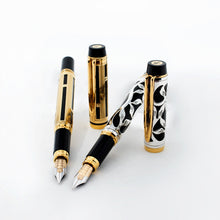 Load image into Gallery viewer, The gold and silver overlay fountain pens arranged with their caps off on a white background.