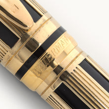 Load image into Gallery viewer, Close up to the Waterman logo engraved on the cap ring of the gold pen.