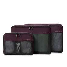 Load image into Gallery viewer, Top panel view of three purple packing cubes with black zippers and mesh fabric filled with clothes.