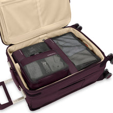 Load image into Gallery viewer, Interior view of a purple suitcase with the three packing cubes organized inside.