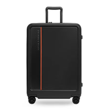 Load image into Gallery viewer, Front view of the black medium suitcase with the telescopic handle partly pulled up.