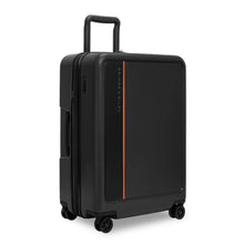 Load image into Gallery viewer, Angled front view of the black medium suitcase with the telescopic handle partway extended.