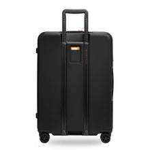 Load image into Gallery viewer, Back panel view of the black medium suitcase. The telescopic handle is pulled part way up.