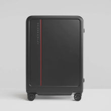 Load image into Gallery viewer, Front panel view of the black suitcase with on a light gray background.