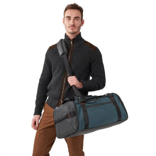 Load image into Gallery viewer, Briggs & Riley Large Travel Duffle - Ocean Blue
Image of ZDX Large Travel Duffle being carried with shoulder strap by male model.
Dimensions:  11 x 23.5 x 13"
Weight:          3.1 lbs.