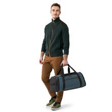 Load image into Gallery viewer, Briggs & Riley Large Travel Duffle - Ocean Blue
Image of ZDX Large Travel Duffle being carried by male model.
Dimensions:  11 x 23.5 x 13"
Weight:          3.1 lbs.