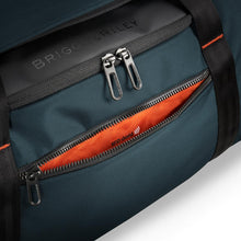 Load image into Gallery viewer, Briggs & Riley Large Travel Duffle - Ocean Blue
Image of front panel pocket with 
RFID shield.  Block digital pickpockets and easily access checkpoint essentials with RFID-shielded SpeedThru™ pocket.
Dimensions:  11 x 23.5 x 13"
Weight:          3.1 lbs.