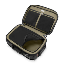 Load image into Gallery viewer, Interior view of the black backpack duffle's main compartment. It has a zipper-closing panel divider and pockets.