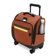 Load image into Gallery viewer, Angled front view of the canyon orange underseat cabin suitcase with black accents. A water bottle and thin yellow book are organized in the compartments.