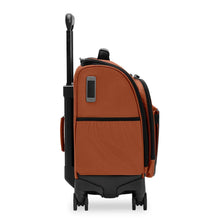 Load image into Gallery viewer, Side panel view of the canyon orange underseat spinner suitcase. It features an open pocket.