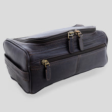 Load image into Gallery viewer, angled view of a dark brown leather toiletry bag with multiple compartments and dark metal zippers