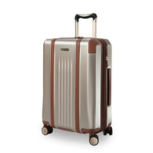 Load image into Gallery viewer, Angled front panel view of the beige suitcase with tan leather accents