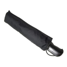 Load image into Gallery viewer, Angled view of the black umbrella in its sleeve on a white background. The handle is black, and it has a thin black strap.