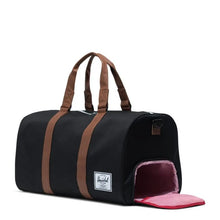 Load image into Gallery viewer, Angled view of the duffle bag with the side panel shoe compartment opened.