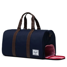 Load image into Gallery viewer, Angled front view of the peacoat chicory duffle bag. The side panel's shoe compartment is unzipped.