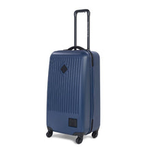 Load image into Gallery viewer, Angled front view of the navy blue Trade spinner suitcase. The telescopic handle is extended.