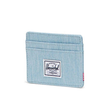Load image into Gallery viewer, Angled front view of the Light Denim Charlie Card Case. A small white Herschel logo tag is sown at the center.