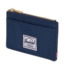 Load image into Gallery viewer, Angled front view of the Navy blue Oscar card case wallet. A small white Herschel logo tag is sown at the center.