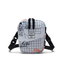 Load image into Gallery viewer, Front view of the World Travel Cruz Crossbody Bag. A white Herschel logo tag is sown at the center.
